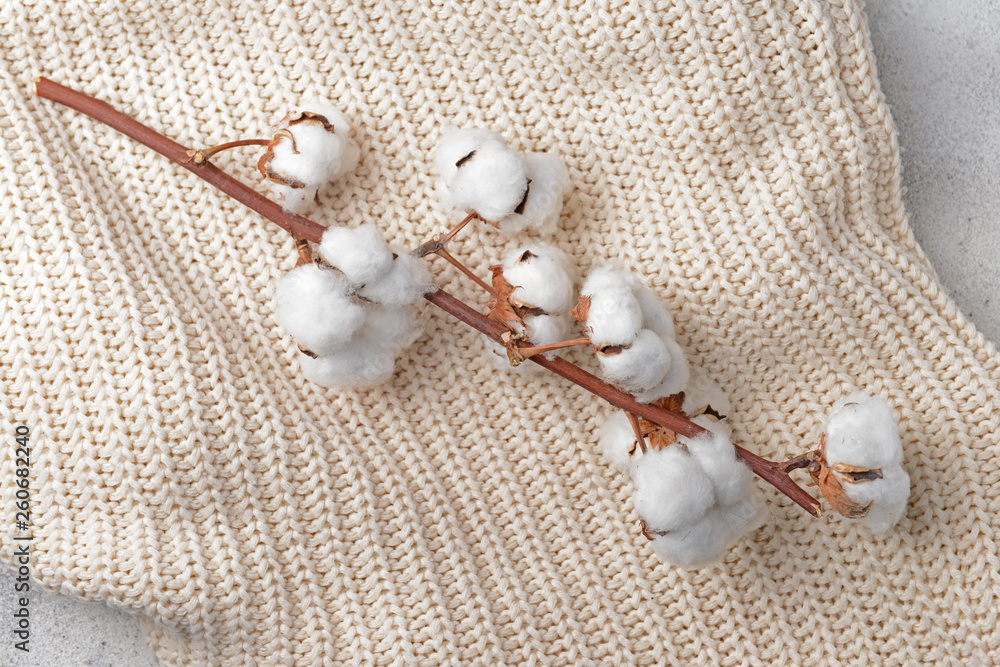 Cotton flowers on knitted plaid