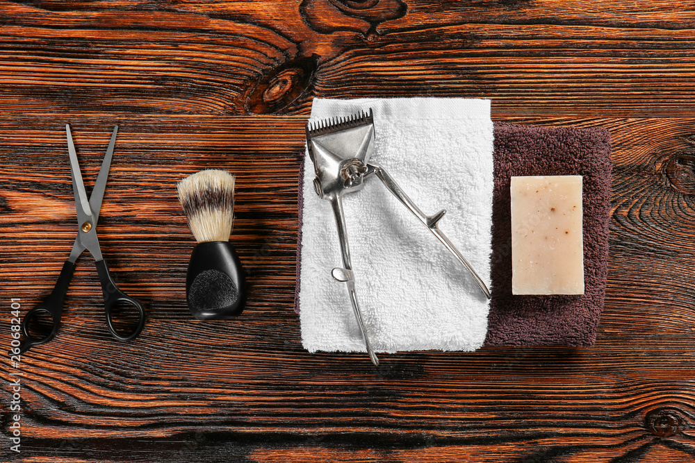 Set of male shaving accessories with hair trimmer on wooden background