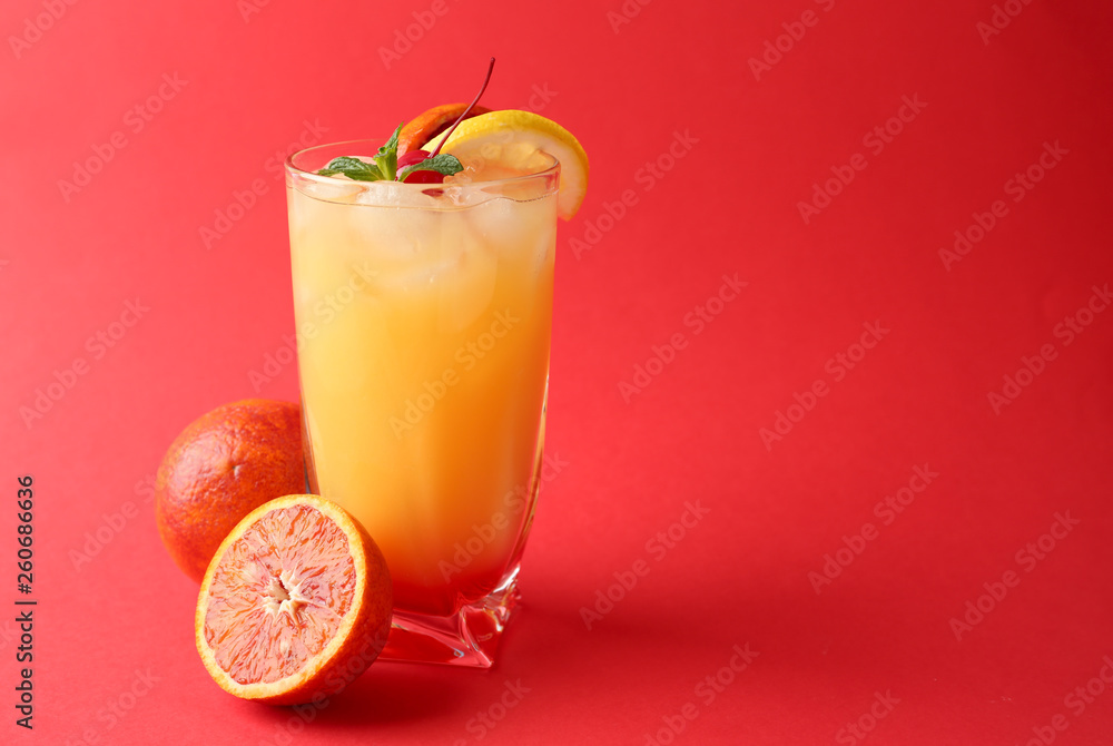 Glass of Tequila Sunrise cocktail on color background