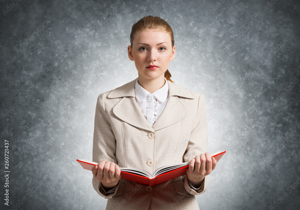 Attractive woman holding open notebook