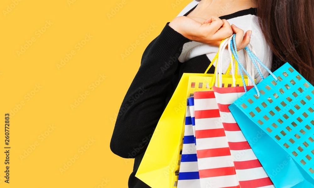 Young woman with shopping bag on  background