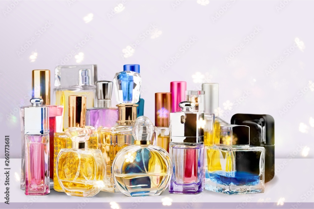 Aromatic Perfume bottles on white wooden desk at wooden background