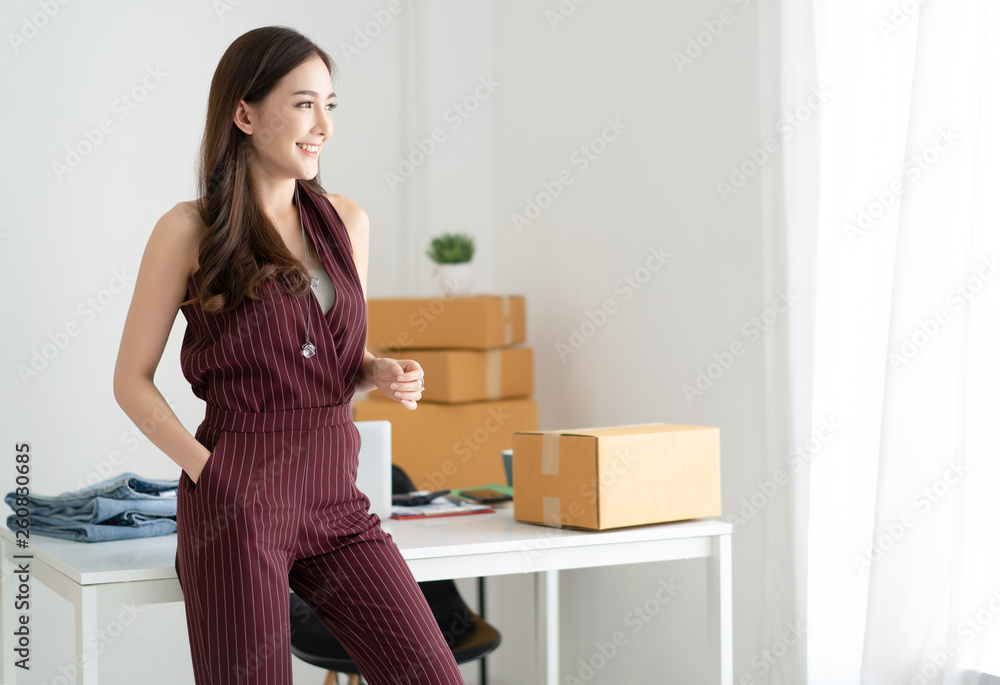 Young Asian casual woman working small business owner standing looking in distance thinking of futur