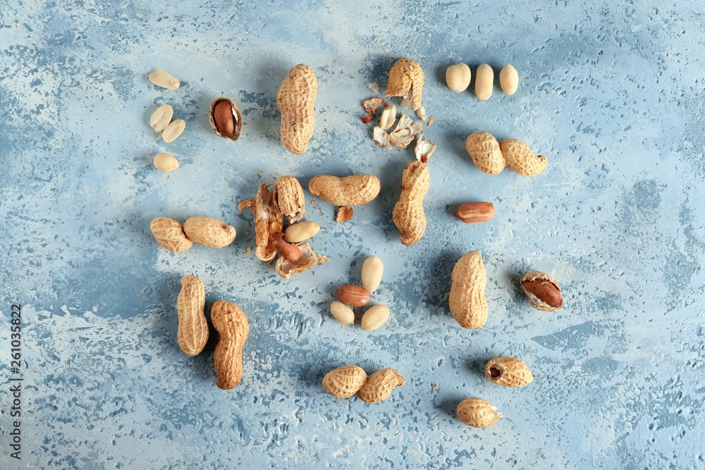 Tasty peanuts on color background