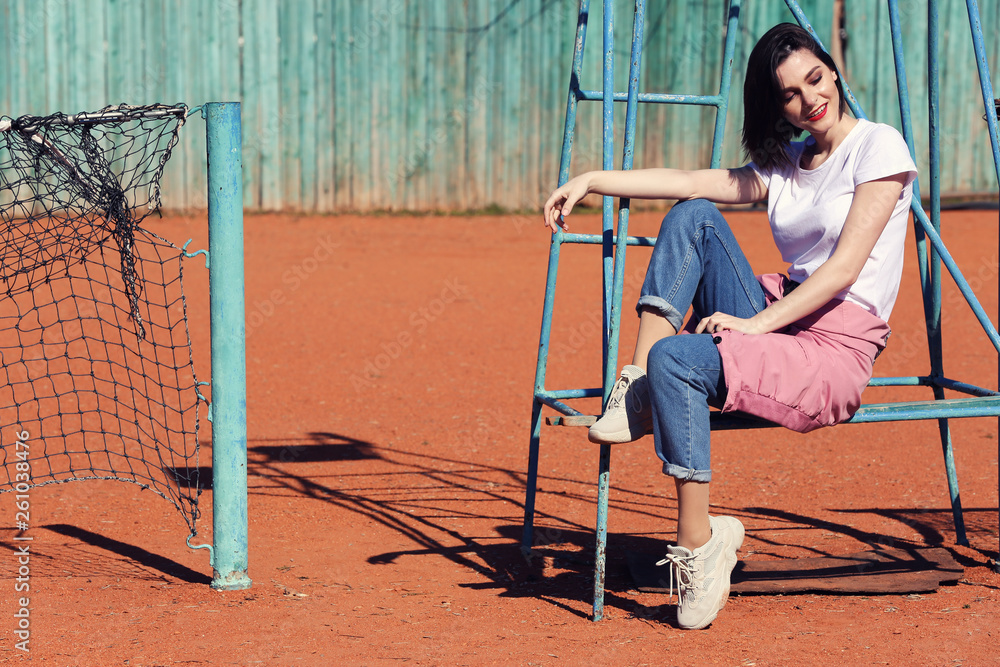 Fashionable young woman on tennis court outdoors