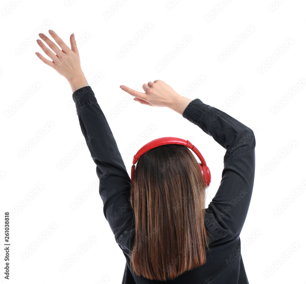 Young woman with headphones listening to music on white background