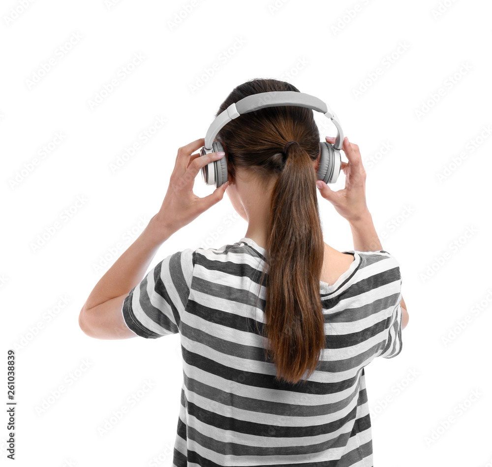 Young woman with headphones listening to music on white background