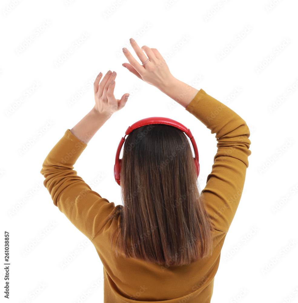 Young woman with headphones listening to music on white background