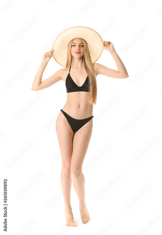 Beautiful young woman in swimming suit on white background