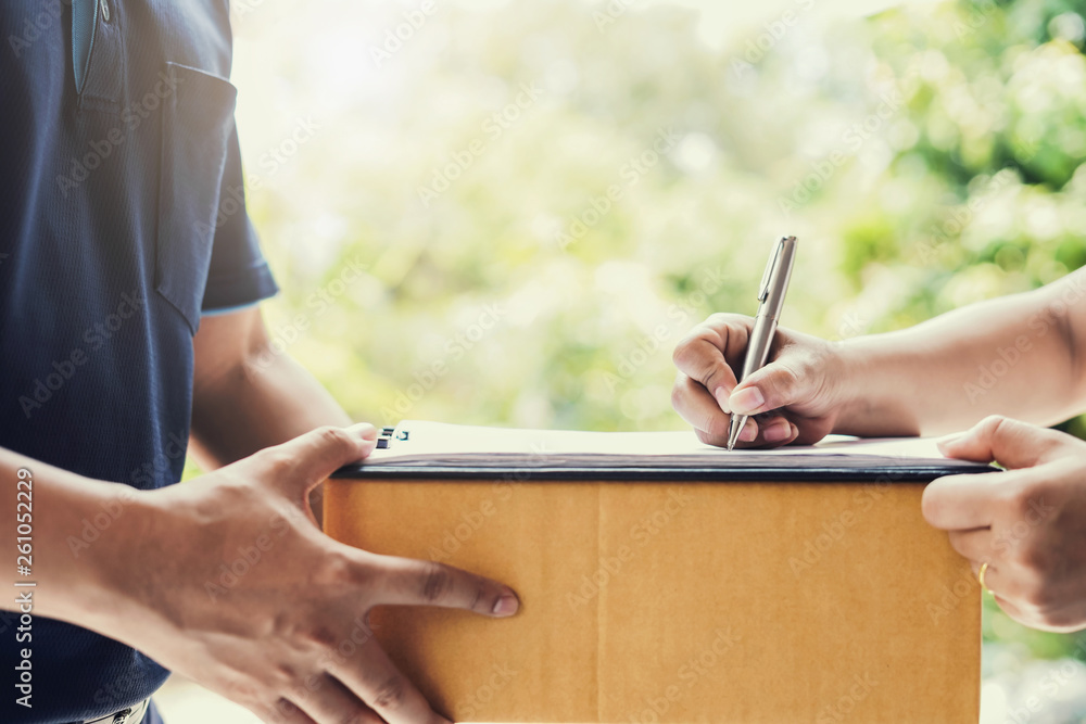 woman hand signature on paper for receiving parcel