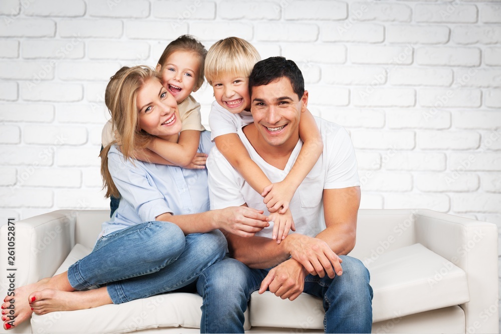 Beautiful smiling family in room on couch