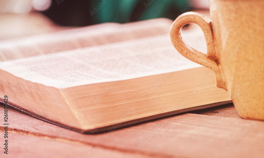 Open book on old wooden table.