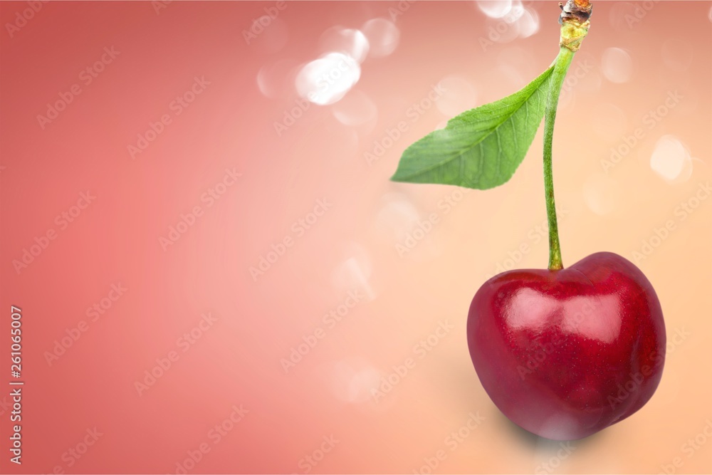 Red ripe cherry with green leaf