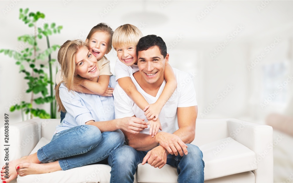 Young  family at home smiling at camera