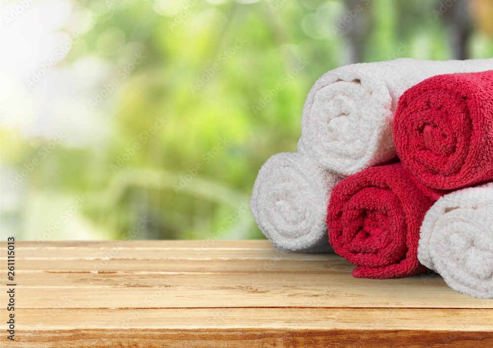 Laundry Basket with colorful towels on background