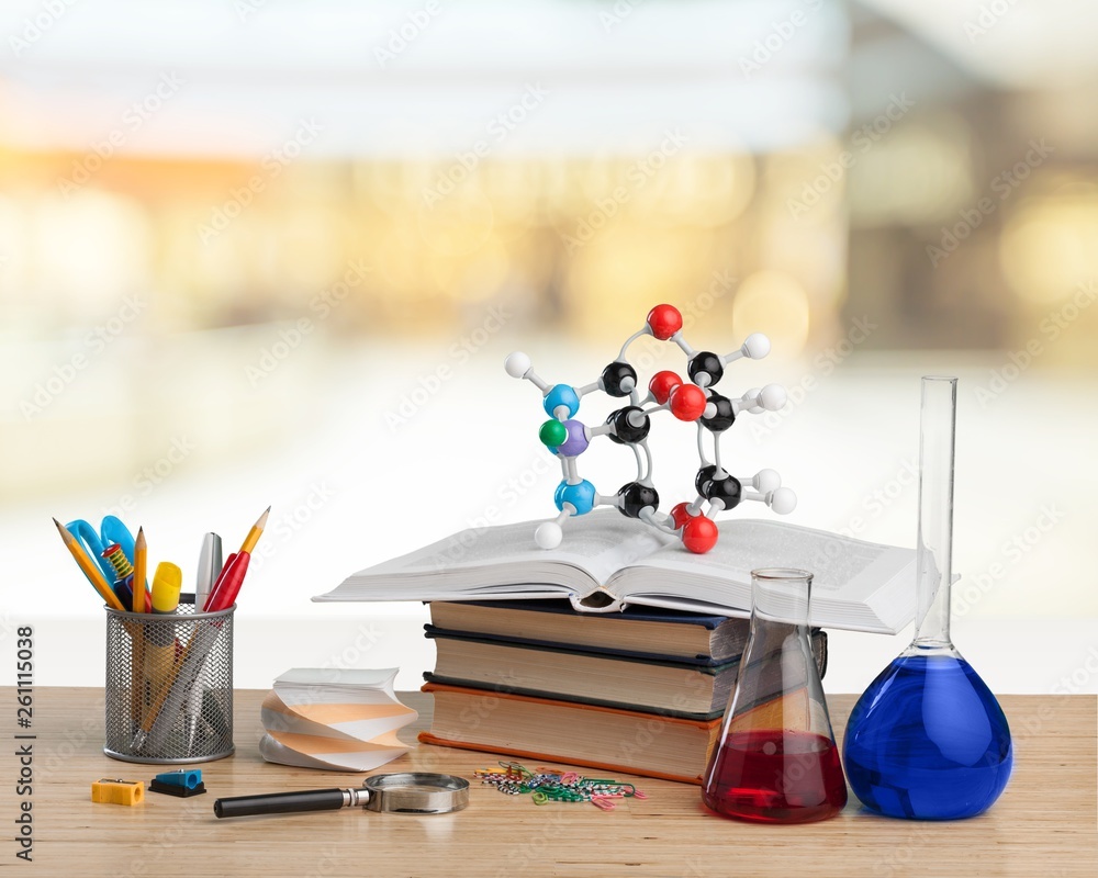 Colorful school supplies on blackboard background