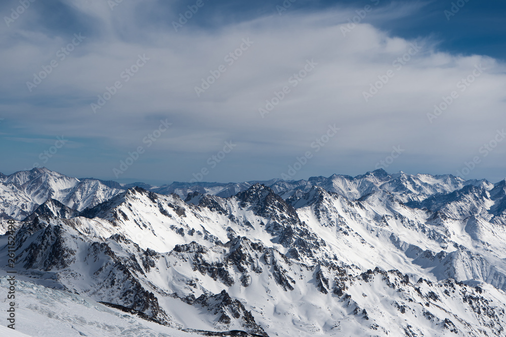 mountains in snow, blue sky, Sunny weather, white snow lying on the mountains