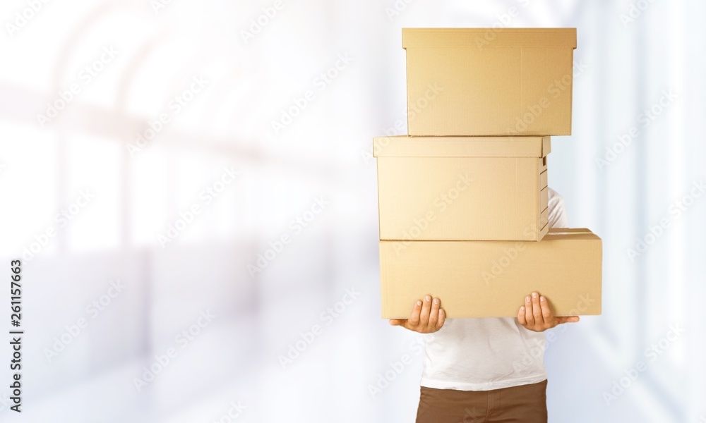 Man with cardboard boxes on background