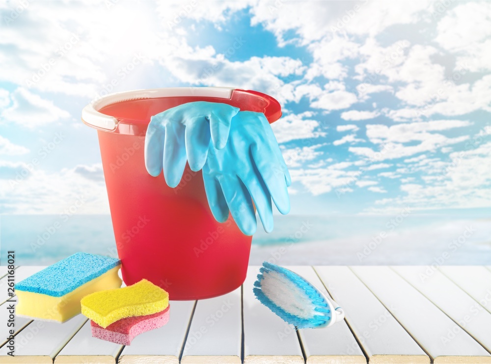 Plastic bottle, cleaning  gloves and bucket on background