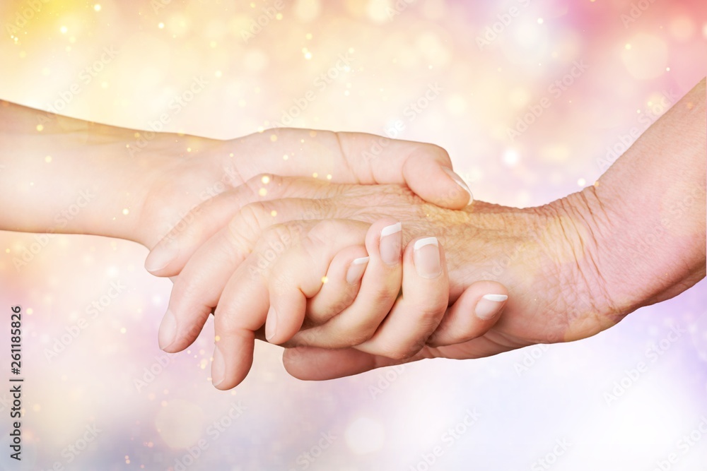 Hands of the old man and a young woman. close up.