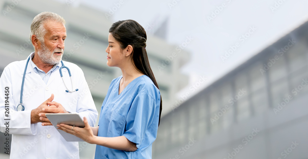 Senior doctor working with young doctor in the hospital. Medical healthcare staff and doctor service