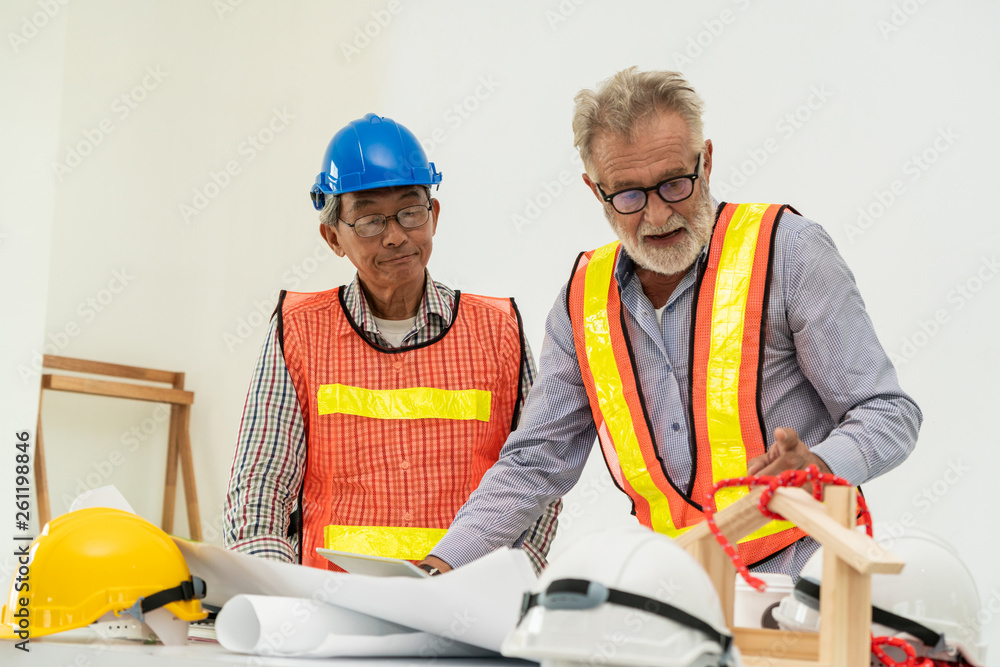 Senior engineers and architect working with construction plan. House building concept.