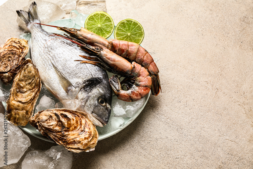 Fresh seafood with ice on grey table