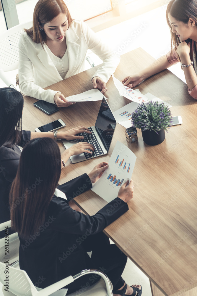 Businesswoman in group meeting discussion with other businesswomen colleagues in modern workplace of