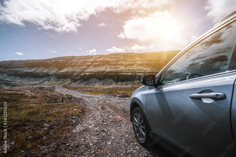 4WD SUV vehicle car running on gravel road with nature mountain landscape in Iceland. Adventure and 