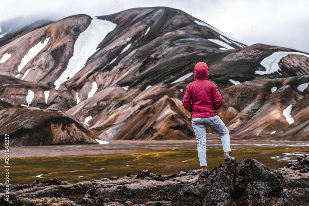 Traveler hiking at Landmannalaugar surreal nature landscape in highland of Iceland, Nordic, Europe. 