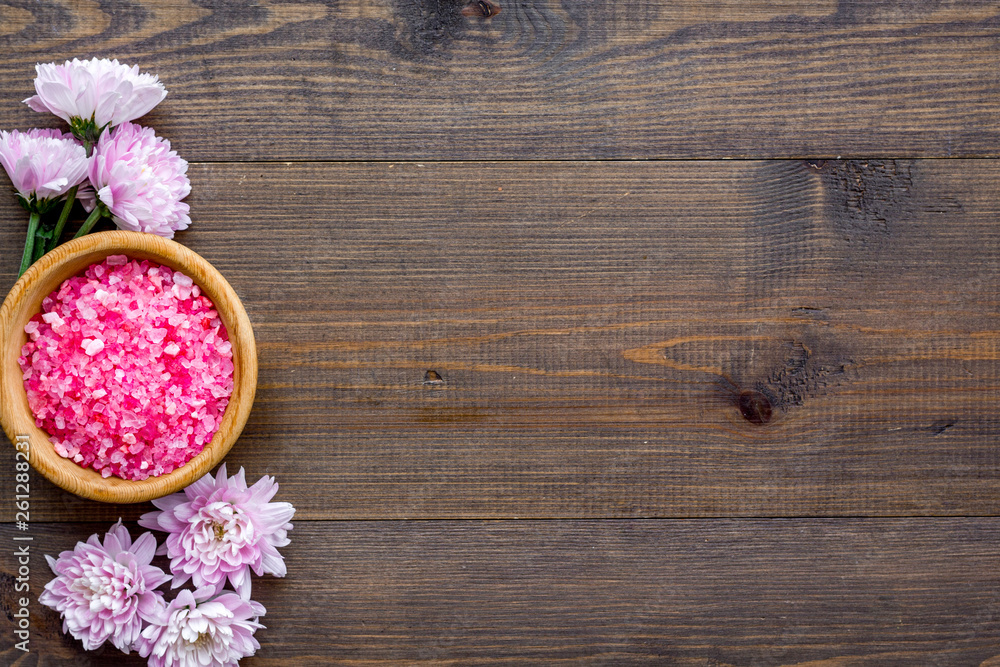 aroma therapy with pink flower fragrance and spa salt on wooden background top view space for text