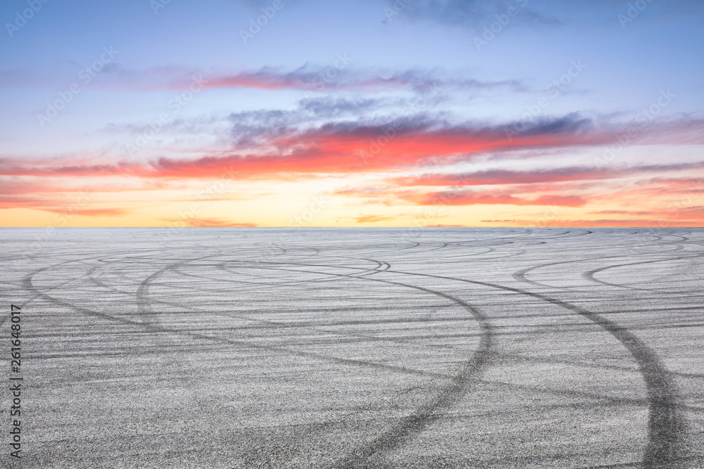 Asphalt race track ground and beautiful sky clouds at sunrise