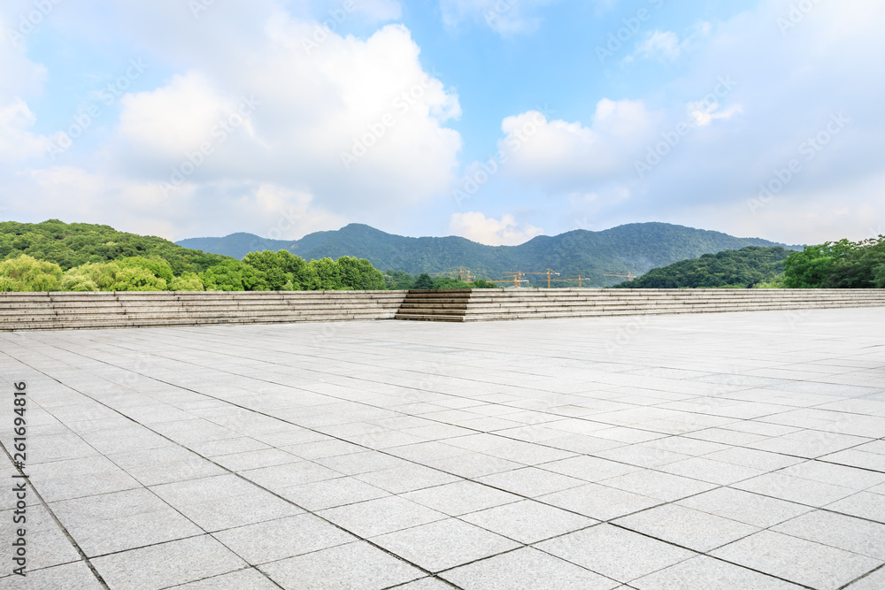 Empty square floor and green mountain with sky landscape