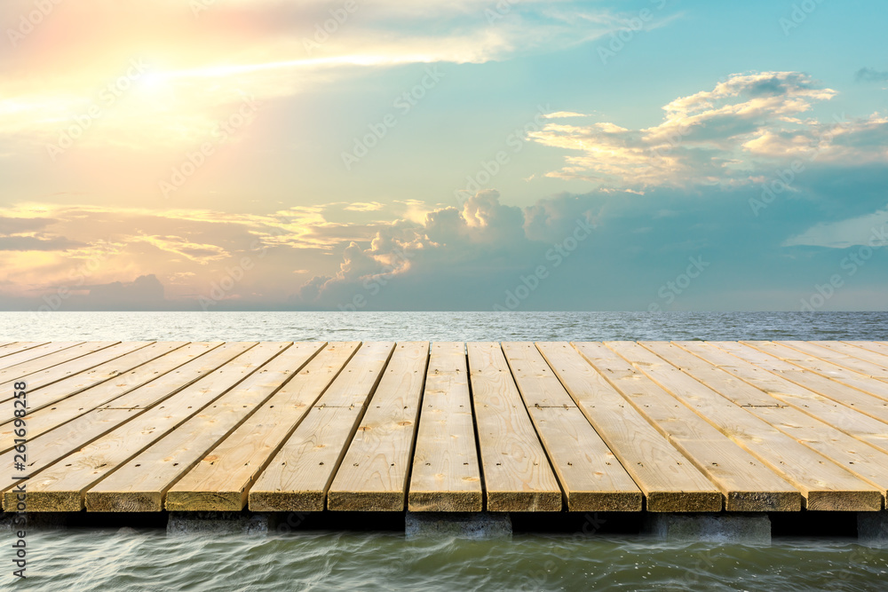 Wooden floor platform and blue sea with sky background