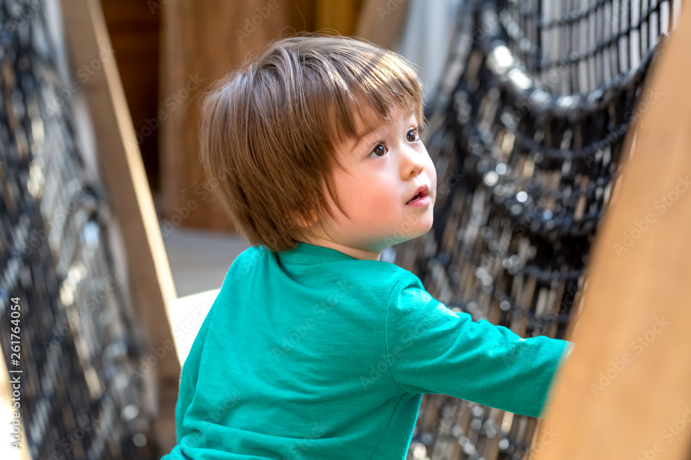 Toddler boy playing outside at a playground