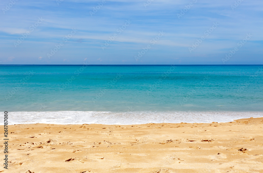 Tropical sandy beach with blue ocean and blue sky background image for nature background or summer b