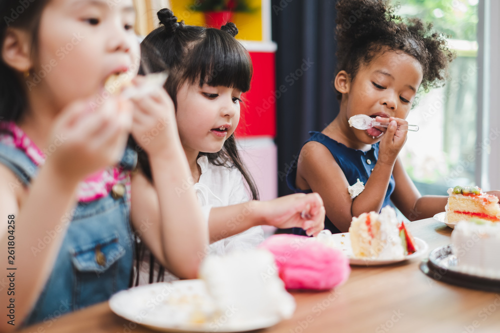 Diversity girl kids eating sweet cake