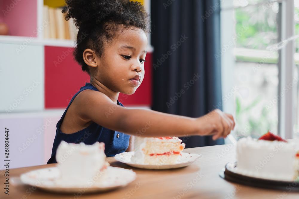 african girl kid eating sweet cake