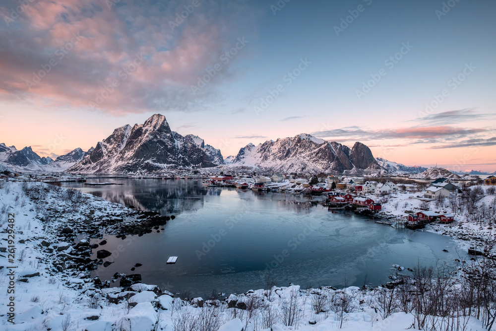 Viewpoint of snow mountain reflection on seashore in reine village