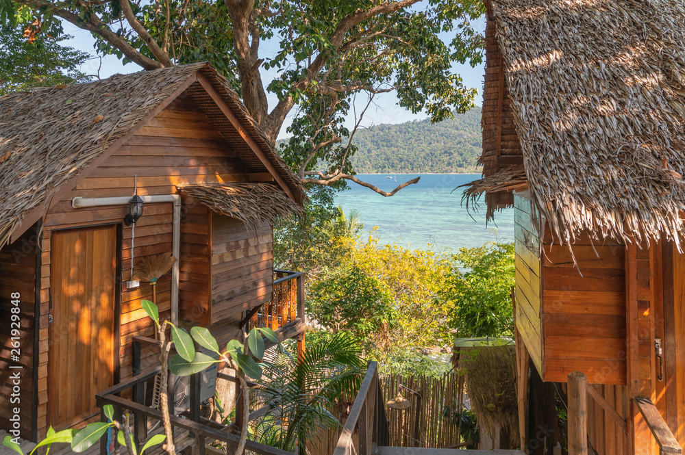 Wooden hut resort on hill with scenic sea