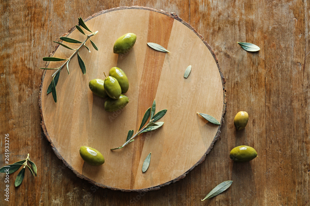 Tasty olives on wooden board