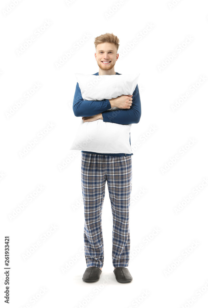 Handsome man with pillow on white background