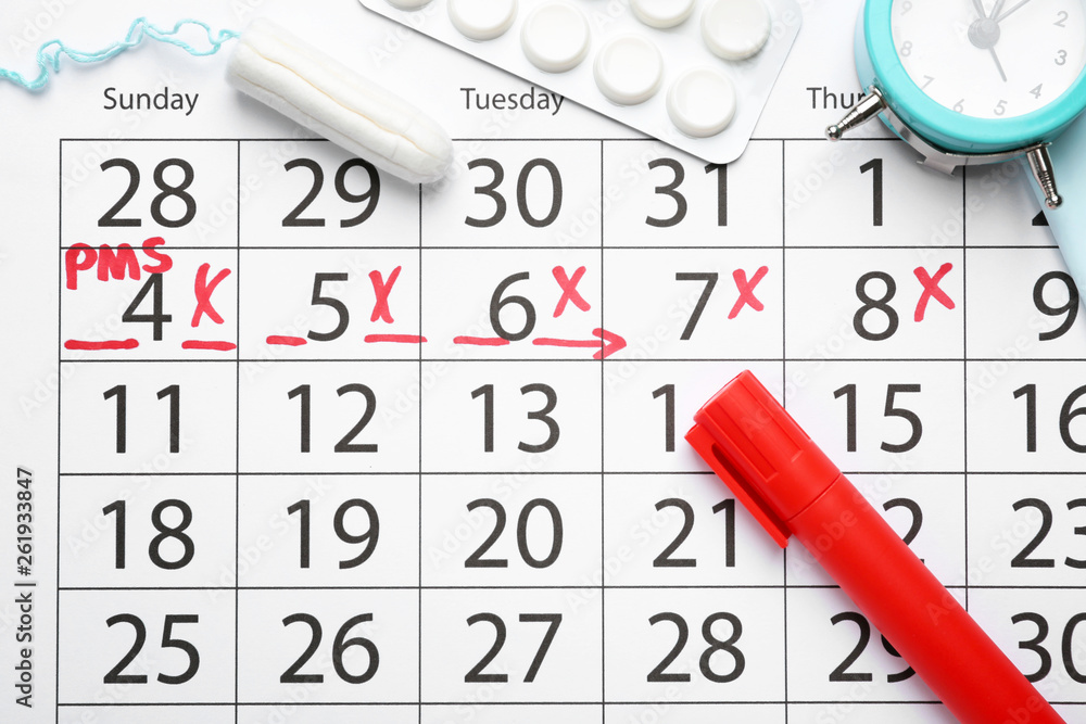 Menstrual calendar with tampon, pills and alarm clock