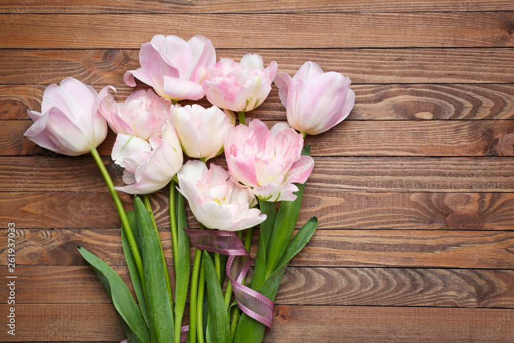 Beautiful tulip flowers on wooden background