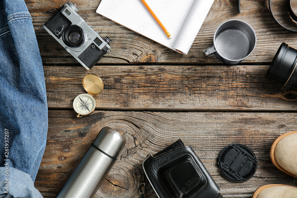 Set of items for tourist on wooden background