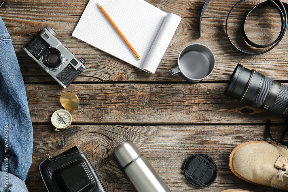 Set of items for tourist on wooden background