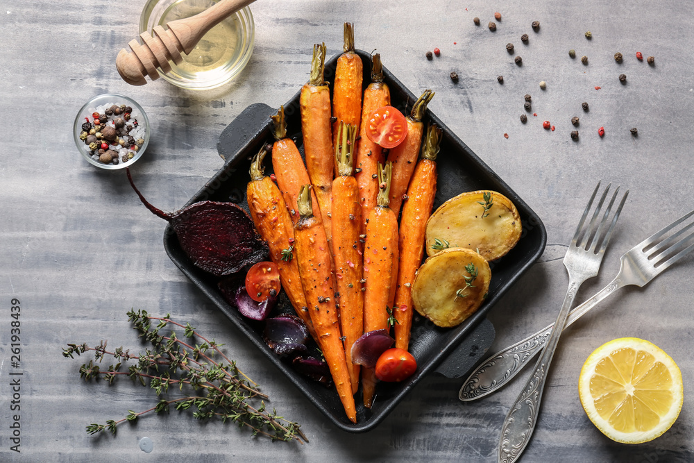 Frying pan with cooked vegetables on table