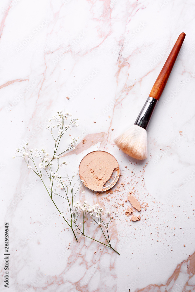 Facial powder with brush on light background