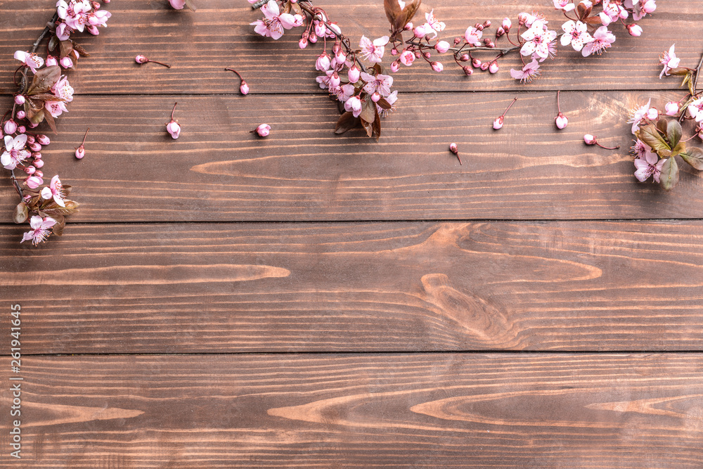 Beautiful blossoming branches on wooden background