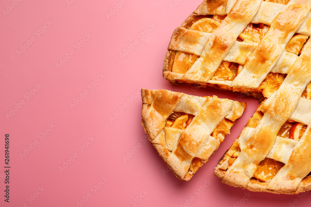 Tasty orange pie on color background